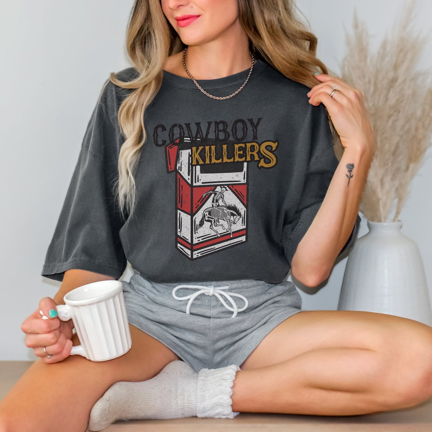 Comfort Colors shirt in pepper with a distressed cowboy killers Western graphic