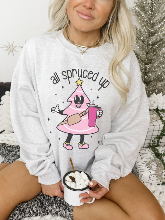 Oversized long sleeve crew neck sweatshirt with a heathered ash grey color. Sweater features a pink Christmas tree with a belt bag and large water bottle that says all spruced up.