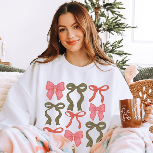 Oversized white crewneck sweatshirt featuring a Christmas coquette bow graphic.