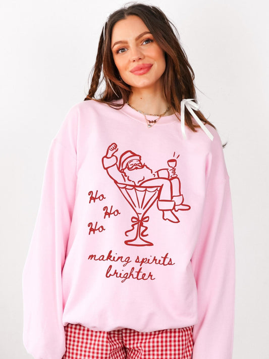 Long sleeve crewneck sweatshirt featuring a red graphic of a Santa in a martini glass with the worlds ho ho ho making spirits brighter.